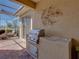 Outdoor grill with tile countertop and prep area, plus screened patio seating area at 13143 Palmilla Cir, Dade City, FL 33525