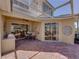 Outdoor patio area with grill, dining table, ceiling fan, and access to screened patio at 13143 Palmilla Cir, Dade City, FL 33525