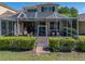 Comfortable screened lanai with lounge furniture and manicured hedges for privacy at 13143 Palmilla Cir, Dade City, FL 33525
