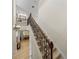 Elegant staircase with decorative wrought iron railings and carpeted steps leading to the upper level at 13143 Palmilla Cir, Dade City, FL 33525