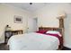 Bedroom boasts light walls, a bed with palm tree patterned bedding, and wood-look floors at 1410 25Th N St, St Petersburg, FL 33713