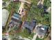 Aerial view of property with mature trees, pool, tile roof, and beautiful landscaping at 14115 Harborwood Dr, Largo, FL 33774