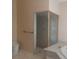 Bathroom featuring decorative glass shower with walk-in shower and commode at 14115 Harborwood Dr, Largo, FL 33774