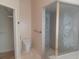 Bathroom with walk-in shower with glass doors and commode at 14115 Harborwood Dr, Largo, FL 33774