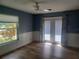 View of bedroom with ceiling fan, wood floors, and french doors at 14115 Harborwood Dr, Largo, FL 33774