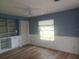 Bedroom featuring a ceiling fan, wood floors, built-in shelving and closet at 14115 Harborwood Dr, Largo, FL 33774