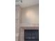 Close-up of a tile fireplace with a black screen in a living room at 14115 Harborwood Dr, Largo, FL 33774