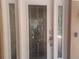 Elegant white front door with decorative glass panels, a digital keypad, and a sturdy handle at 14115 Harborwood Dr, Largo, FL 33774