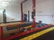Functional garage featuring car lifts and checker-patterned flooring at 14115 Harborwood Dr, Largo, FL 33774