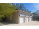 Image shows detached three-car garage and exterior of home at 14115 Harborwood Dr, Largo, FL 33774