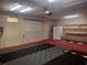 A three-car garage with updated flooring, peg-board, workspace and a freezer at 14115 Harborwood Dr, Largo, FL 33774
