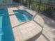 Close up of hot tub with stone trim, next to the pool with stone trim at 14115 Harborwood Dr, Largo, FL 33774