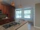 Bright kitchen with granite counters, ample counter space, and views of the screened-in pool area at 14115 Harborwood Dr, Largo, FL 33774