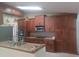 Kitchen featuring custom cabinetry, granite counters, stainless appliances, and ample counter space at 14115 Harborwood Dr, Largo, FL 33774