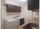 Laundry room area featuring utility sink, cabinets, washer, and dryer at 14115 Harborwood Dr, Largo, FL 33774