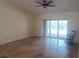 Spacious living room with travertine floors, a ceiling fan, and sliding doors to the pool area at 14115 Harborwood Dr, Largo, FL 33774