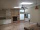 Open-concept living room featuring a fireplace, skylight, and built-in shelving at 14115 Harborwood Dr, Largo, FL 33774