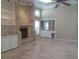 Bright living room with a fireplace, built-in shelving, and a tiled floor at 14115 Harborwood Dr, Largo, FL 33774