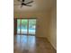 Bright living room features tiled flooring, a ceiling fan, and sliding glass doors leading to the outdoor pool area at 14115 Harborwood Dr, Largo, FL 33774