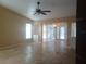 Spacious living room featuring tile floors, a ceiling fan, and natural light at 14115 Harborwood Dr, Largo, FL 33774