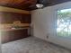 Outdoor kitchen featuring wooden cabinetry and a sink with a window view of lush greenery at 14115 Harborwood Dr, Largo, FL 33774
