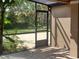 Screened porch view to backyard with pavers, offering a private outdoor retreat perfect for relaxing or entertaining at 14115 Harborwood Dr, Largo, FL 33774