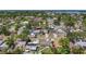 Birds eye view of neighborhood, with mature trees, and homes with solar panels and pools at 1734 Shore Acres Ne Blvd, St Petersburg, FL 33703