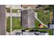Overhead view displays the property's roof, driveway, and backyard with patio and tidy landscaping at 1734 Shore Acres Ne Blvd, St Petersburg, FL 33703