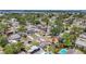 Aerial shot of neighborhood with lush trees, waterfront views, and homes with pools at 1734 Shore Acres Ne Blvd, St Petersburg, FL 33703