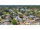 Aerial shot of home and neighborhood near a body of water, with mature trees and well-kept yards at 1734 Shore Acres Ne Blvd, St Petersburg, FL 33703