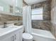 Modern bathroom with white vanity and bathtub with shower at 1734 Shore Acres Ne Blvd, St Petersburg, FL 33703