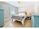 This bedroom has a ceiling fan, two windows, and wood floors at 1734 Shore Acres Ne Blvd, St Petersburg, FL 33703