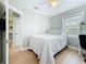 A neutral bedroom with a ceiling fan and a window at 1734 Shore Acres Ne Blvd, St Petersburg, FL 33703