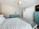 Bright bedroom with a ceiling fan, large closet, and blue dressers providing ample storage space at 1734 Shore Acres Ne Blvd, St Petersburg, FL 33703