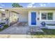 Charming home featuring a bright blue front door and an open carport at 1734 Shore Acres Ne Blvd, St Petersburg, FL 33703