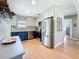 Modern kitchen with stainless steel appliances, white cabinets, and unique backsplash at 1734 Shore Acres Ne Blvd, St Petersburg, FL 33703