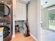 Laundry area with stacked washer/dryer, storage closet, and room for cleaning supplies at 1734 Shore Acres Ne Blvd, St Petersburg, FL 33703