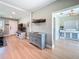 Open-concept living room featuring wood floors and view to kitchen at 1734 Shore Acres Ne Blvd, St Petersburg, FL 33703
