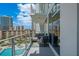 Relaxing balcony with modern furniture and expansive views of the pool and city skyline at 175 1St S St # 1003, St Petersburg, FL 33701