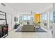 Open-concept living room boasts sleek floors, neutral tones and expansive windows overlooking the city at 175 1St S St # 1003, St Petersburg, FL 33701