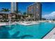 Gorgeous community pool with clear blue water, surrounded by palm trees and lounge areas at 175 1St S St # 1003, St Petersburg, FL 33701
