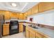 Well-lit kitchen features wood cabinets, stainless steel appliances, and a double sink at 201 Laurel # 308, Tampa, FL 33602