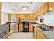 Bright kitchen featuring a stainless steel refrigerator, black oven and a double sink at 201 Laurel # 308, Tampa, FL 33602