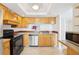 Well-lit kitchen with stainless steel appliances, tile flooring and wooden cabinets at 201 Laurel # 308, Tampa, FL 33602