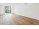 Spacious living room with wood-look flooring and sliding glass doors to a balcony with city views at 201 Laurel # 308, Tampa, FL 33602