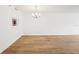 A brightly lit living room with a modern chandelier and wood flooring at 201 Laurel # 308, Tampa, FL 33602