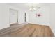 An open-concept living room with wood floors, a stylish chandelier, and decorative window at 201 Laurel # 308, Tampa, FL 33602