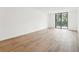 Bright and open living area with modern wood flooring and sliding glass doors to the outside balcony at 201 Laurel # 308, Tampa, FL 33602