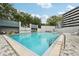 Relaxing community pool with lounge chairs and lush landscaping in a park-like setting at 201 Laurel # 308, Tampa, FL 33602
