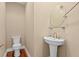 Half bathroom with a pedestal sink, oval mirror, and wood floors at 2226 Soho Bay Ct, Tampa, FL 33606